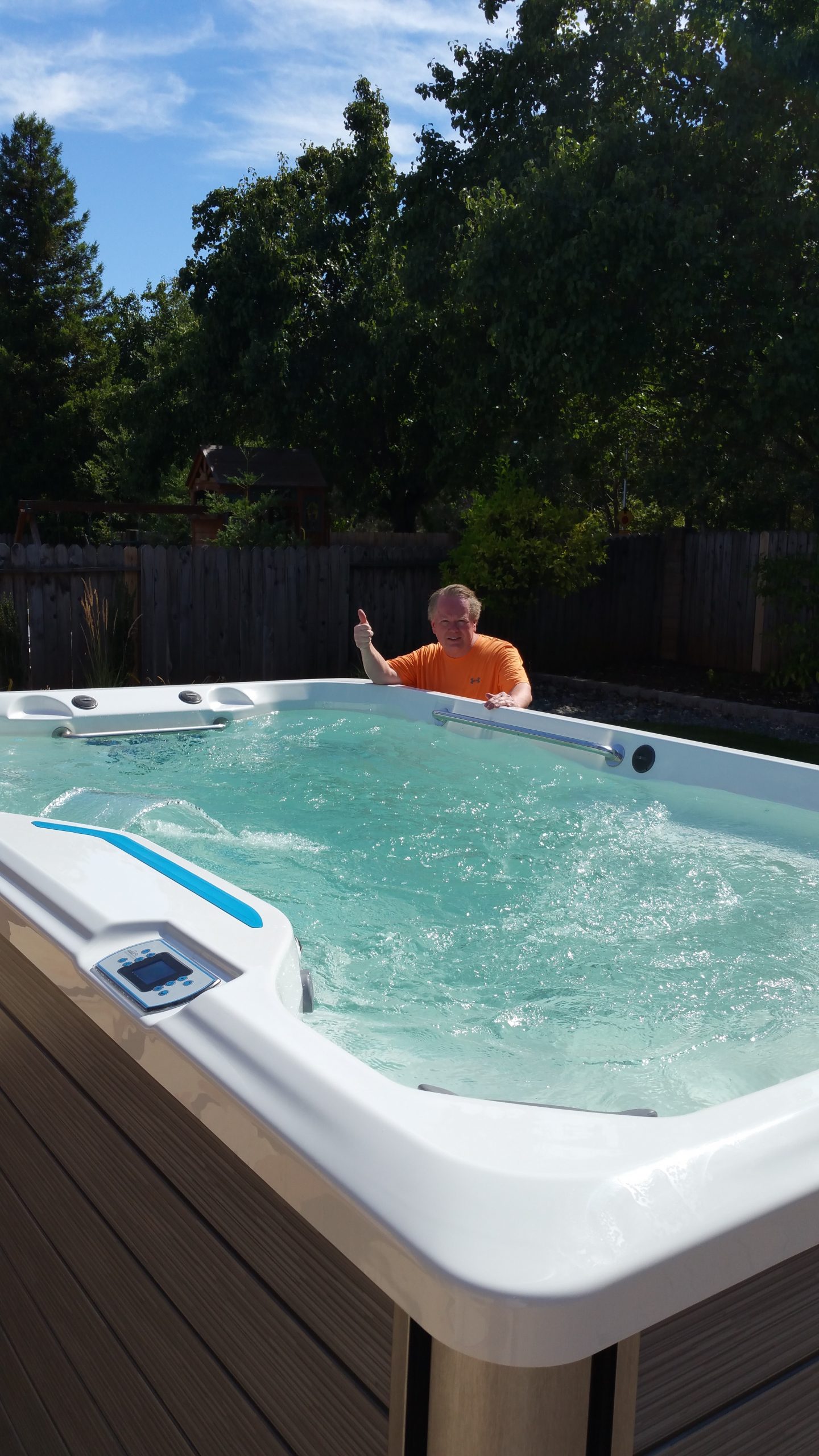 man holding thumbs up with swim spa in Redding, CA