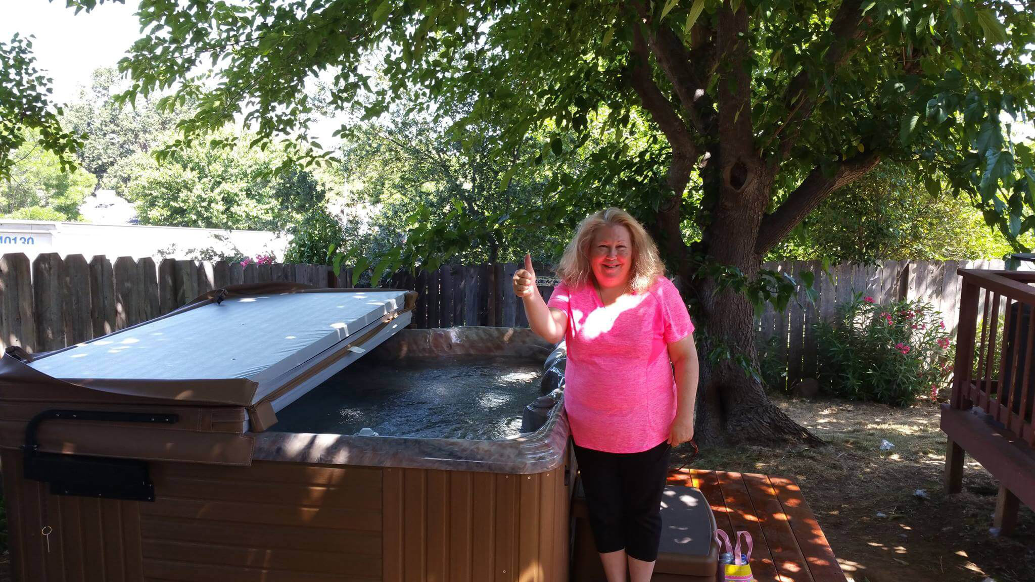 Woman smiling with her hot tub delivery